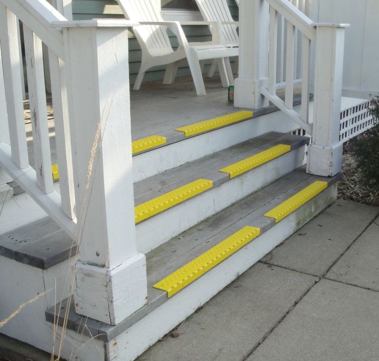 https://stoptheslip.com/wp-content/uploads/2019/10/handi-treads-yellow-nosing-wood-steps.jpg
